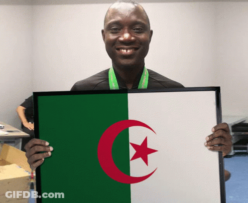 A Man Holds A Framed Picture Of The Algerian Flag GIF