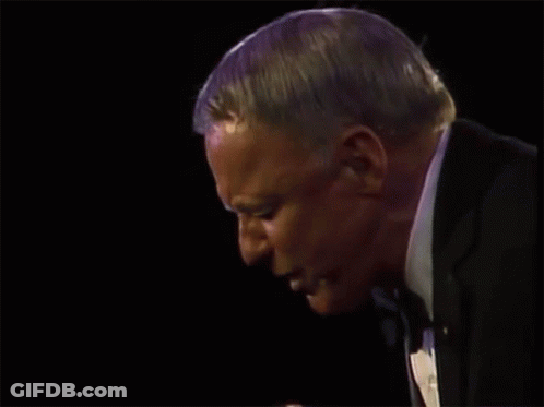 A Man Holds A Microphone And Says Anywhere GIF