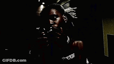 A Man Holds A Stack Of 100 Dollar Bills In His Mouth GIF