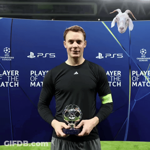 A Man Holds A Trophy In Front Of A Ps5 Banner GIF