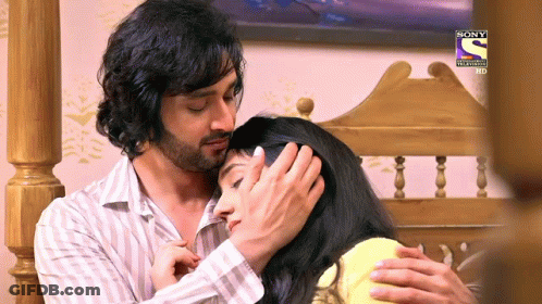 A Man Holds A Woman 'S Head With A Sony Logo On The Bottom GIF