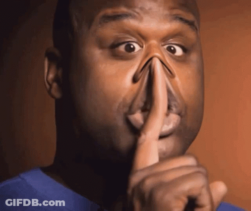 A Man Holds His Finger To His Mouth While Making A Funny Face GIF