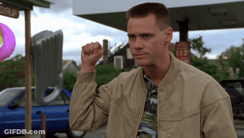 A Man Holds His Fist Up In Front Of A Sign That Says 113 Cents GIF