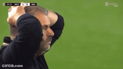 A Man Holds His Head In His Hands While Watching A Soccer Game GIF