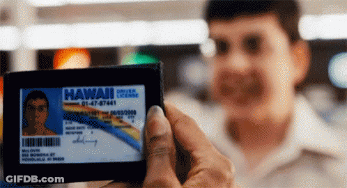 A Man Holds Up A Hawaii License Card GIF