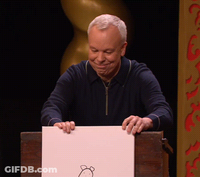 A Man Holds Up A Piece Of Paper With A Drawing Of A Bear On It GIF