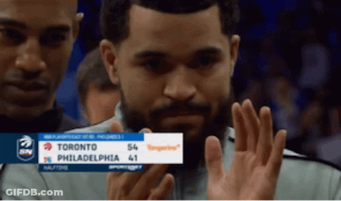 A Man Holds Up A Sign That Says Toronto Philadelphia 41 On It GIF