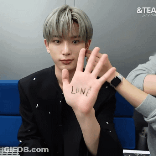 A Man Holds Up His Hand With The Word Lone On It GIF