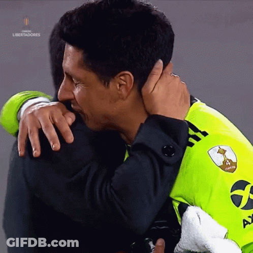 A Man Hugging Another Man With The Word Libertadores In The Corner GIF