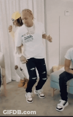 A Man In A 2Louis Shirt Is Dancing GIF