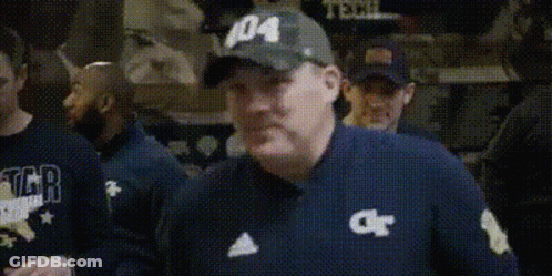 A Man In A Baseball Cap Is Holding A Bottle Of Medicine In His Hand . GIF