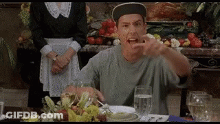 A Man In A Baseball Cap Is Sitting At A Table With A Glass Of Water And A Plate Of Food . GIF