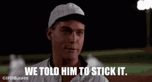 A Man In A Baseball Cap Is Standing On A Baseball Field And Says `` We Told Him To Stick It '' . GIF