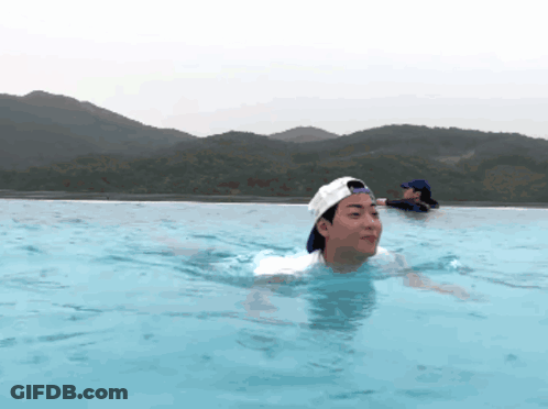 A Man In A Baseball Cap Is Swimming In A Pool GIF