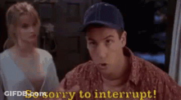 A Man In A Baseball Cap Is Talking To A Woman In A Room . GIF