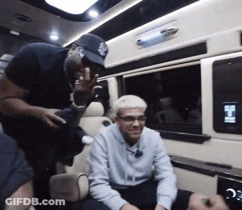 A Man In A Baseball Cap Is Talking To Another Man In A Car GIF