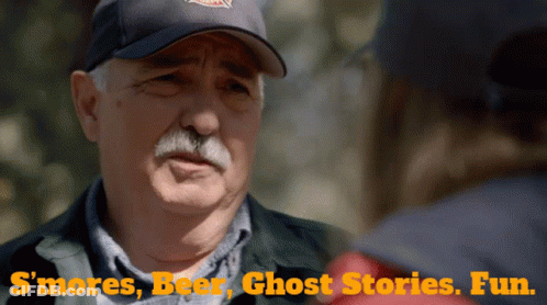 A Man In A Baseball Cap Is Talking To Another Man With The Words " S'mores Beer Ghost Stories Fun " On The Bottom GIF