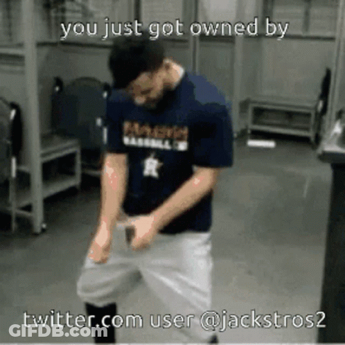 A Man In A Baseball Uniform Is Dancing In A Locker Room GIF