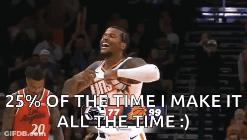 A Man In A Basketball Uniform Is Holding A Basketball And Laughing While Another Man Stands Behind Him . GIF