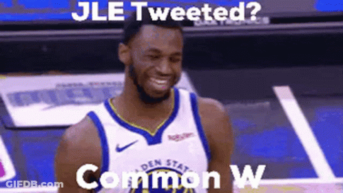 A Man In A Basketball Uniform Is Smiling On A Court . GIF