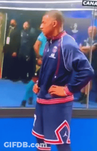 A Man In A Basketball Uniform With The Number 7 On His Shorts Is Standing With His Hands On His Hips . GIF