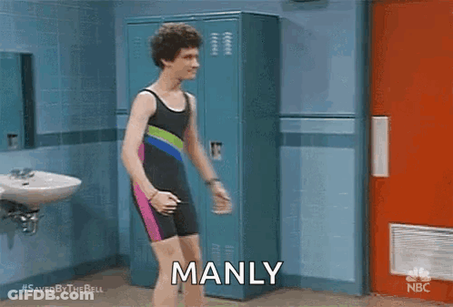 A Man In A Bathing Suit Is Standing In A Locker Room And Saying `` Manly '' . GIF