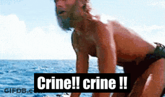 A Man In A Bathing Suit Is Standing In The Ocean With The Words Crine !! Crine !! Behind Him GIF