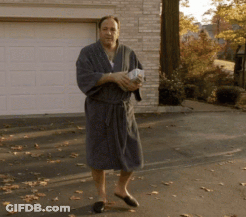 Man In Bathrobe And Slippers Holding Paper GIF