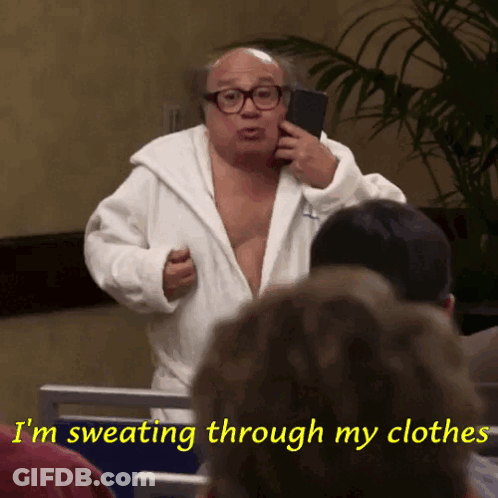 A Man In A Bathrobe Is Sweating Through His Clothes And Talking On A Cell Phone GIF