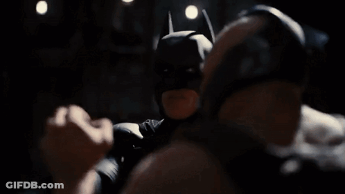 A Man In A Batman Mask Is Standing Next To Another Man In A Dark Room And Says Victory Has Defeated You . GIF