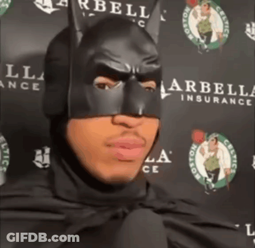 Man In Batman Mask Standing In Front Of Celtics Sign GIF
