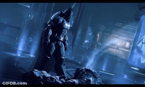 A Man In A Batman Suit Is Standing Next To Another Man GIF