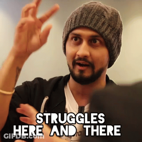 A Man In A Beanie Says " Struggles Here And There " With His Hand GIF
