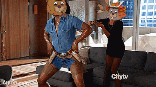 A Man In A Bear Mask Is Dancing In A Living Room With A Citytv Logo In The Background GIF