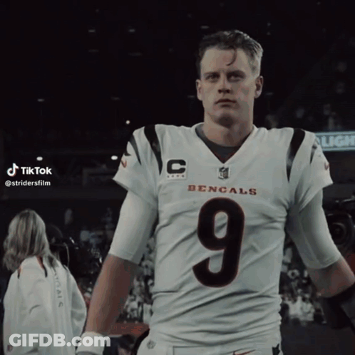 A Man In A Bengals Jersey With The Number 9 On His Chest GIF