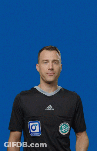 A Man In A Black Adidas Shirt Is Holding A Yellow Card GIF