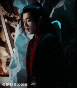 A Man In A Black And Red Costume Is Standing In The Dark GIF