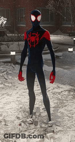 A Man In A Black And Red Spider-Man Suit Is Standing In The Snow GIF