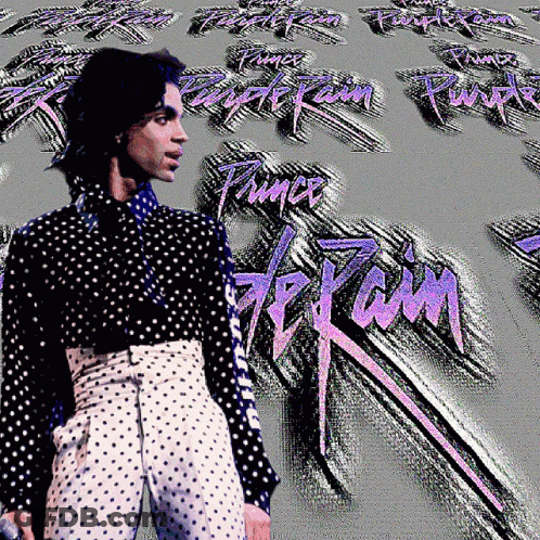 A Man In A Black And White Polka Dot Shirt Stands In Front Of A Purple Rain Background GIF