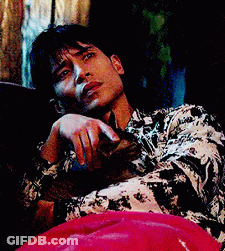 Man In Black And White Shirt Lying On Couch GIF