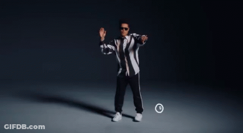 A Man In A Black And White Striped Jacket Is Dancing In Front Of A Circle With The Letter D On It GIF