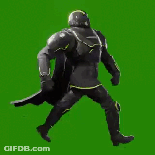 A Man In A Black Armor Is Walking On A Green Screen . GIF