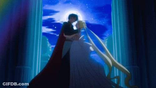 A Man In A Black Cape And A Woman In A White Dress Are Kissing GIF