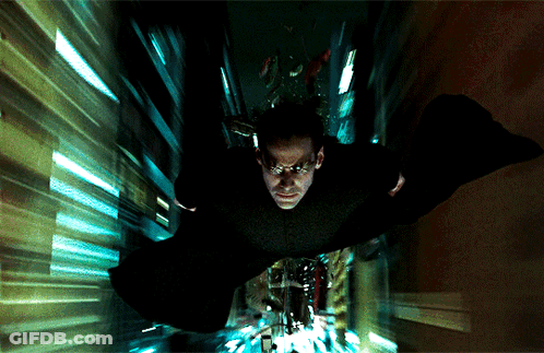 A Man In A Black Cape Is Flying Through A Tunnel GIF