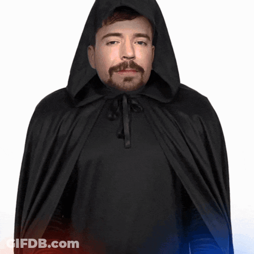 A Man In A Black Cape With A Hood Is Holding A Red And Blue Light GIF
