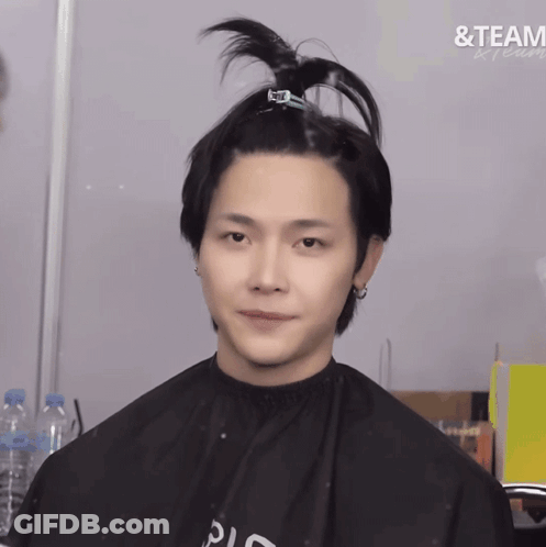 A Man In A Black Cape With The Word Team Written On The Bottom GIF