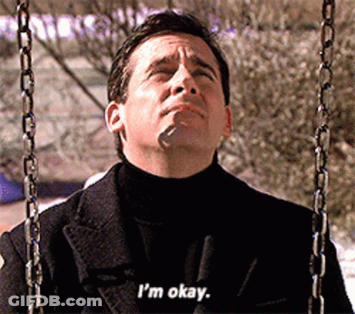 A Man In A Black Coat Is Sitting On A Swing And Says I 'M Okay GIF
