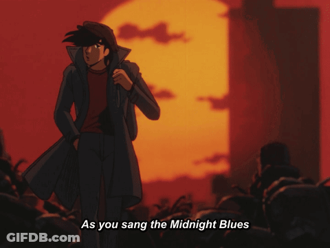 A Man In A Black Coat Is Standing In Front Of A Sunset With The Words As You Sang The Midnight Blues Below Him GIF