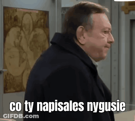 A Man In A Black Coat Is Standing In Front Of A Wall With A Painting On It . GIF