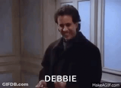 A Man In A Black Coat Is Standing In Front Of A Window With The Word Debbie Written On His Face . GIF